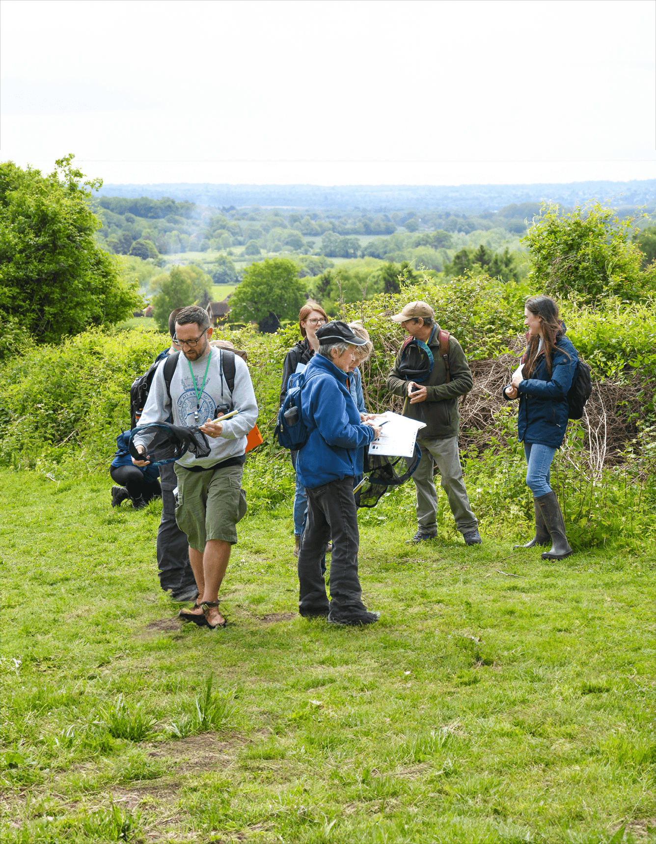 A group of people standing on top of a lush green field